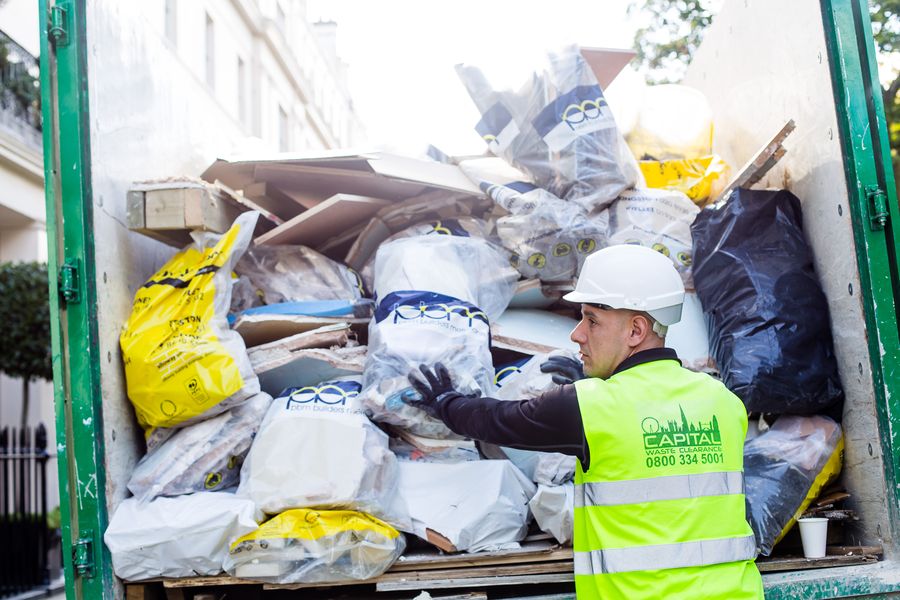 Capital Waste Clearance operative loading builders waste into truck